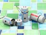 Drei USB-Sticks in Form von Heizungen, bedruckt mit den Logos AQUAPUR und SOLTOP, auf buntem Fliesenhintergrund.