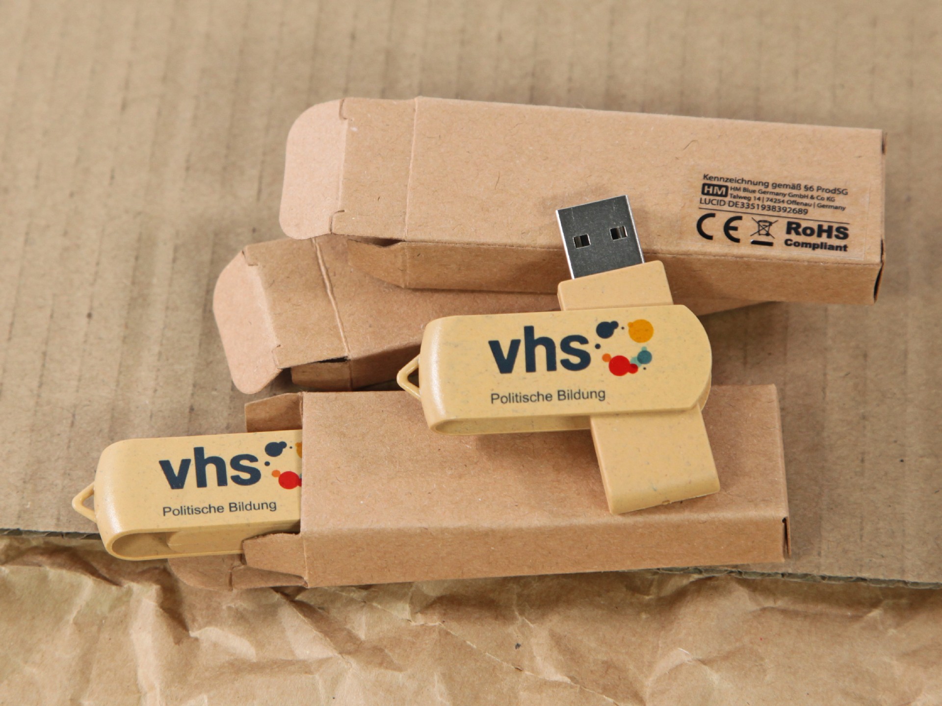 USB-Stick in natürlicher Optik mit farbigem Logo-Bereich und Verpackung für individuelle Gestaltung.